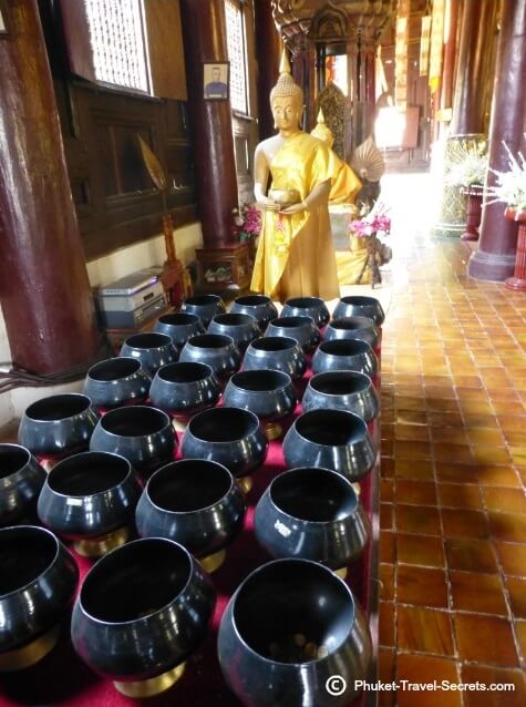 Buddha Images and pots within the prayer hall at Wat Phan Tao
