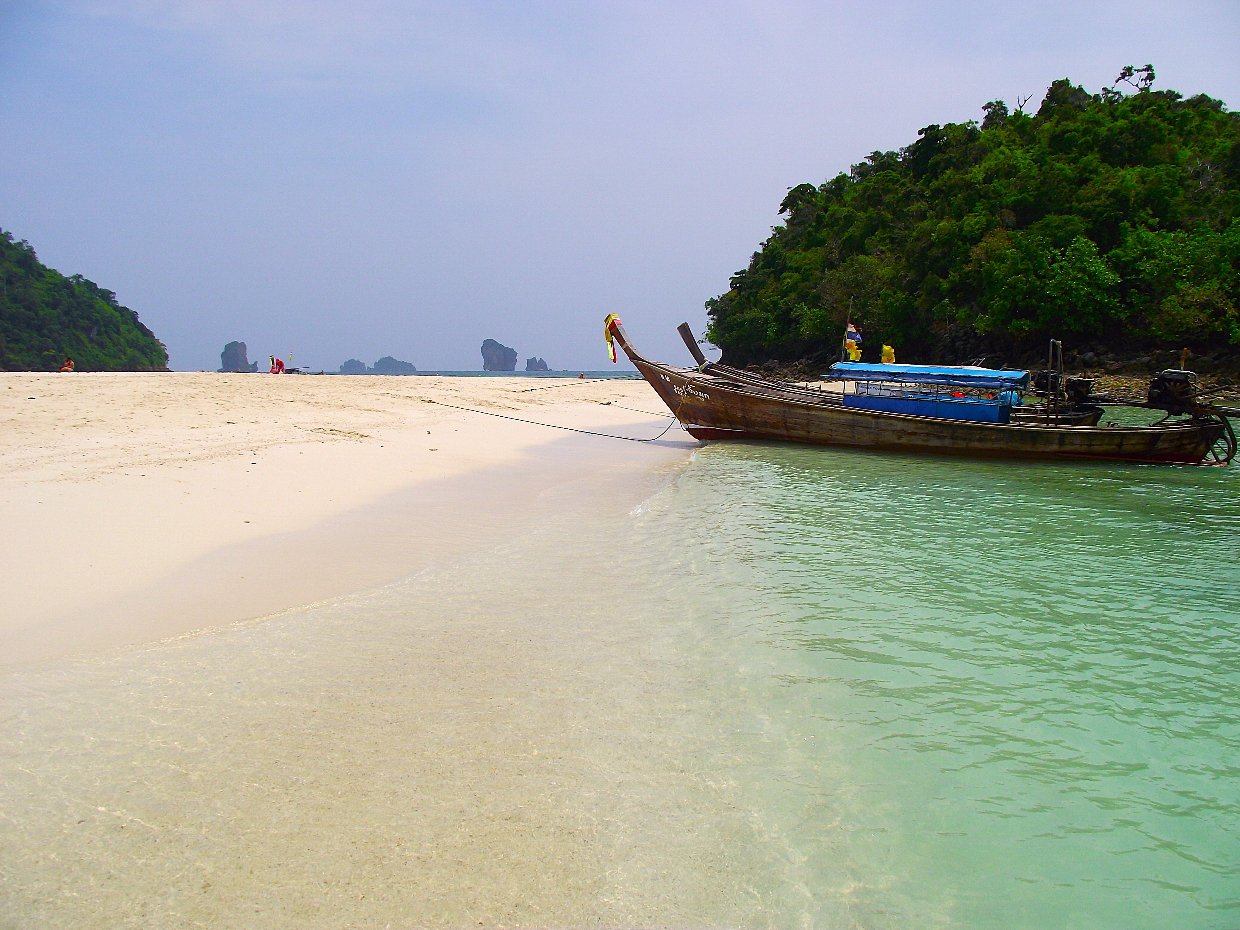 Longtail boats anchored at Tup Island Arriving at Tup Island