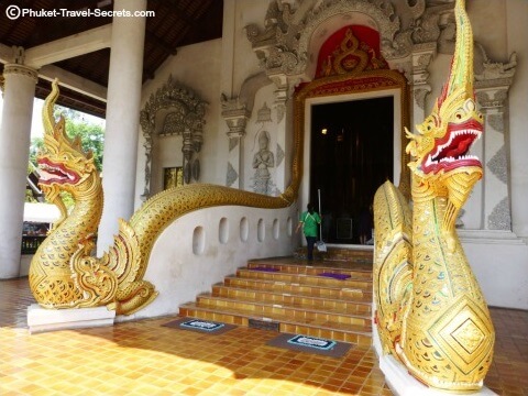 Methodological serpents winding their way up the stairs and around the doorway of the main Viharn at Chedi Luang.. Methodological serpents winding their way up the stairs and around the doorway of the main Viharn at Chedi Luang.
