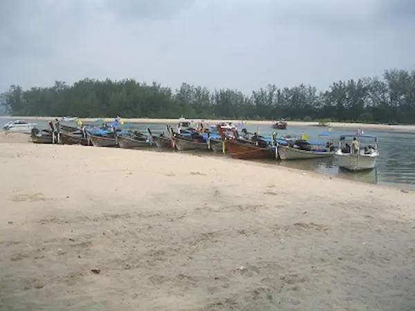 Longtail Boats at the pier at Nopparat Thara Beach. Nopparathara Pier & Inlet