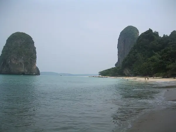 Happy Island is just offshore from Phra Nang Beach in Krabi. Rock formations along the beachfront at Phra Nang