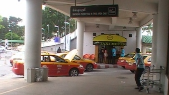 Turn right when exiting the arrival area to find the local red and yellow taxi service.