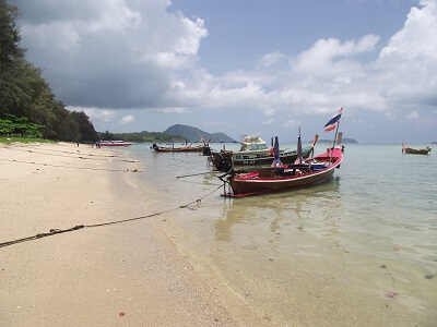 Longtail boats along the beach at Rawai to take visitors to the offshore islands