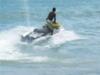 Jet ski operator before driving his ski up onto the beach