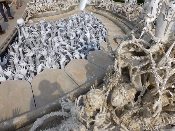 up reaching hands from the pit of hell at Wat Rong Khun. up reaching hands from the pit of hell at Wat Rong Khun.